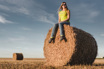 Naklejka na ściany i meble Young woman outdoors in a corn field