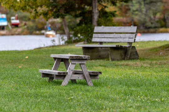 Wooden Bench In The Park With Childs' Picnic Table In Foreground