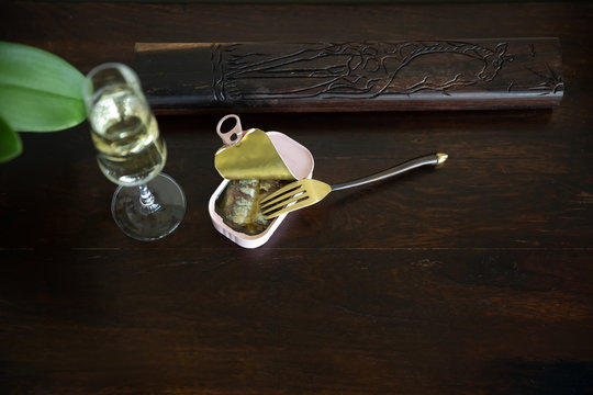Champagne and sardine in a can