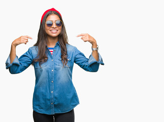 Obraz na płótnie Canvas Young beautiful arab woman wearing sunglasses over isolated background looking confident with smile on face, pointing oneself with fingers proud and happy.