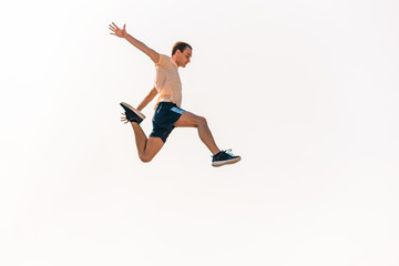 Fototapeta na wymiar Young parkour man jumping in skatepark