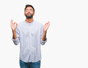 Naklejka premium Adult hispanic man over isolated background relax and smiling with eyes closed doing meditation gesture with fingers. Yoga concept.