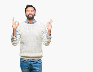 Adult hispanic man wearing winter sweater over isolated background relax and smiling with eyes closed doing meditation gesture with fingers. Yoga concept.