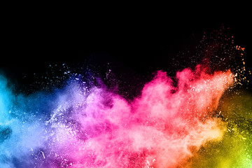 abstract colored dust explosion on a black background.abstract powder splatted background,Freeze motion of color powder exploding/throwing color powder, multicolored glitter texture. © kitsana