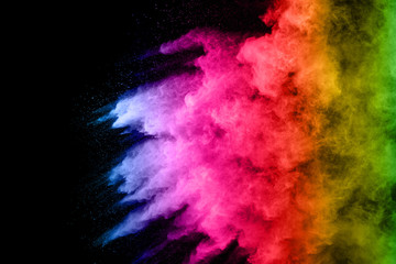 abstract colored dust explosion on a black background.abstract powder splatted background,Freeze motion of color powder exploding/throwing color powder, multicolored glitter texture.