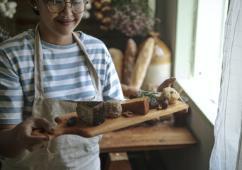 Woman holding a cheese board