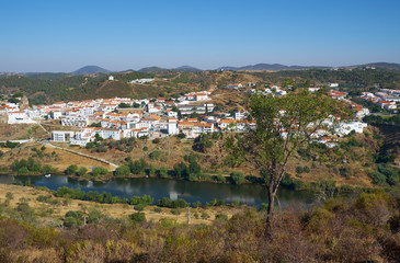 Fototapeta na wymiar Mertola town as seen from the high opposite riverside of the Guadiana. Portugal