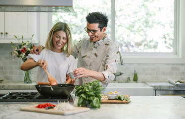 Happy couple cooking in the kitchen