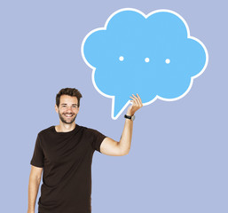 Cheerful man holding a blank speech bubble symbol