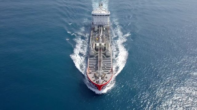 Large crude oil tanker roaring across The Mediterranean sea - Aerial footage following the ship