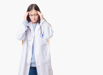 Fototapeta premium Young Chinese doctor woman over isolated background with hand on head for pain in head because stress. Suffering migraine.