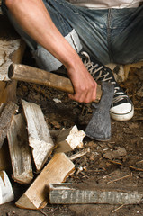 axe in men's hands and chopped wood