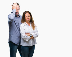 Middle age hispanic business couple over isolated background suffering from headache desperate and stressed because pain and migraine. Hands on head.