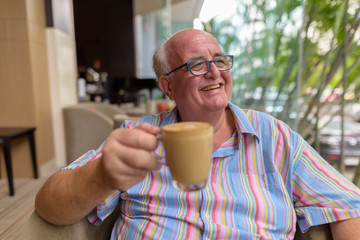 Overweight senior tourist man exploring around the city of Bangk