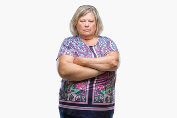 Senior plus size caucasian woman over isolated background skeptic and nervous, disapproving expression on face with crossed arms. Negative person.