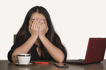 depressed Asian Korean business woman working in stress at office computer desk feeling frustrated suffering headache and depression covering face with hands