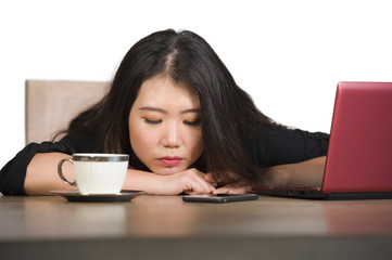 beautiful sad and depressed Asian Korean business woman working in stress at office computer desk...