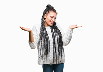 Young braided hair african american girl wearing sweater over isolated background clueless and...