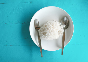 rice on white plate with blue background