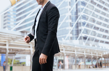 Businessman standing outdoor in city,Lifestyle with positive attitude expressing energy in good time,Cropped image