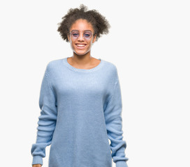 Young afro american woman wearing glasses over isolated background with a happy and cool smile on face. Lucky person.