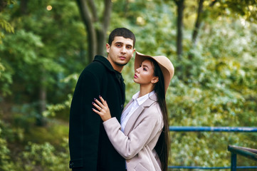 A couple in love on a walk in the city Park on an autumn day . People in coats