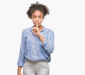 Young afro american woman over isolated background asking to be quiet with finger on lips. Silence and secret concept.