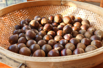 Chestnuts close up in a wooden basket.