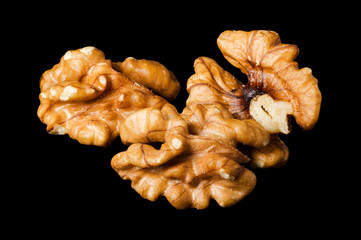 Walnut kernels, nuts isolated on black background