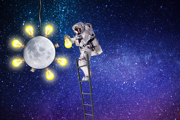 astronaut an electrician replaces a light bulb.moon lighting.elements of this image furnished by NASA