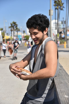 Happy Man Eating Pizza On The Pier