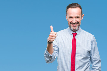 Middle age hoary senior business man wearing red tie over isolated background doing happy thumbs up gesture with hand. Approving expression looking at the camera with showing success.