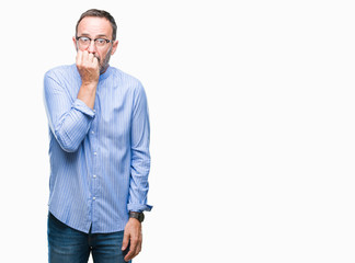 Middle age hoary senior man wearing glasses over isolated background looking stressed and nervous with hands on mouth biting nails. Anxiety problem.