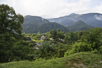 Summer landscape in the mountains - a cute little village is located on the side of a mountain