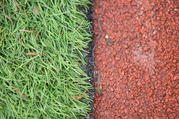 Artificial track and field with green grass combined with artificial grass