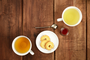 An overhead photo of tea on a dark wooden background with copy space