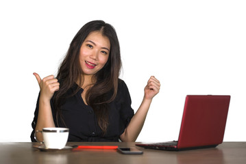 young beautiful and happy successful Asian Chinese businesswoman working relaxed at office computer desk smiling confident posing corporate in business success