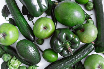 green vegetables and fruits on white background. overhead view