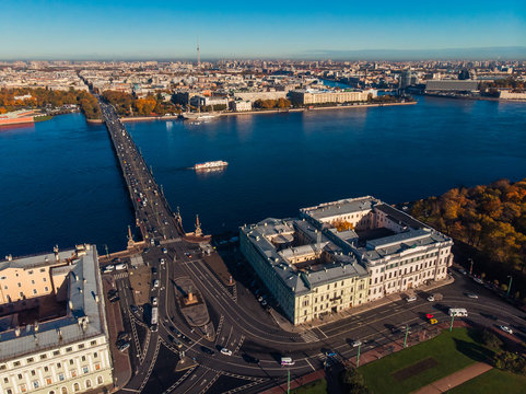 Difficult cross road. Troitsky bridge. Active movement. Autumn parks. Sun in St. Petersburg. Pleasure boat on Neva river. Top view aerial drone .