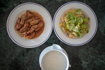 Top view of breakfast set of Thai porridge.