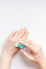 Woman moisturizing her hands with foam lotion