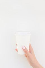 Mock up of coffee cup in female hand