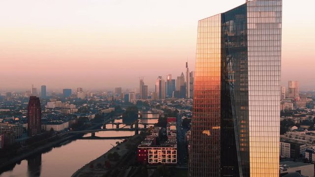 Frankfurt ECB Skyline Aerial Shot at early sunrise reflecting sun