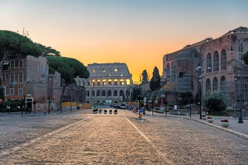 Zelfklevend Fotobehang Sunrise in Rome, Italy. View of the Colosseum from Roman street in morning Rome-Italy. © lucky-photo