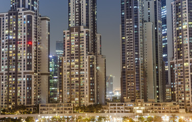 Fototapeta na wymiar modern buildings in Dubai city, night scene. UAE