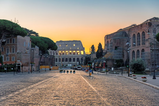 Fototapeta Sunrise in Rome, Italy. View of the Colosseum from Roman street in morning Rome-Italy.
