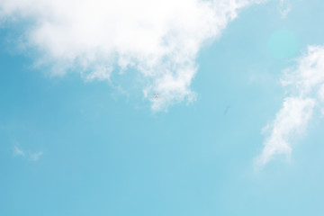 sun and cumulus white clouds against a beautiful blue sky, fly plane