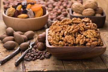 walnut peeled in wooden bowl on table, grunge style.
