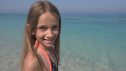 Child on Beach, Happy Smiling Kid on Seashore, Little Girl Laughing at Camera © CreativeZone