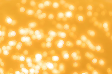Yellow bokeh background texture. Golden blurred bright glare of light texture